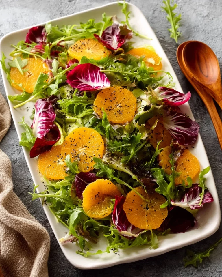 Bitter Leaf Salad with orange slices and poppyseed dressing on a plate