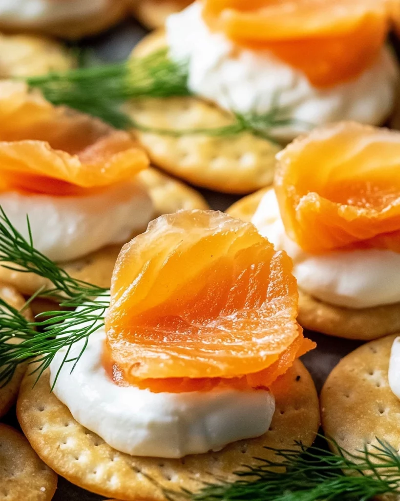 Delicious blini topped with smoked salmon, served on a white plate.