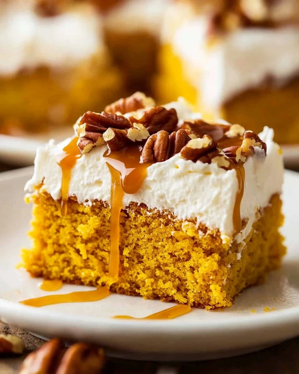 Delicious pumpkin cake with cream cheese frosting served on a plate