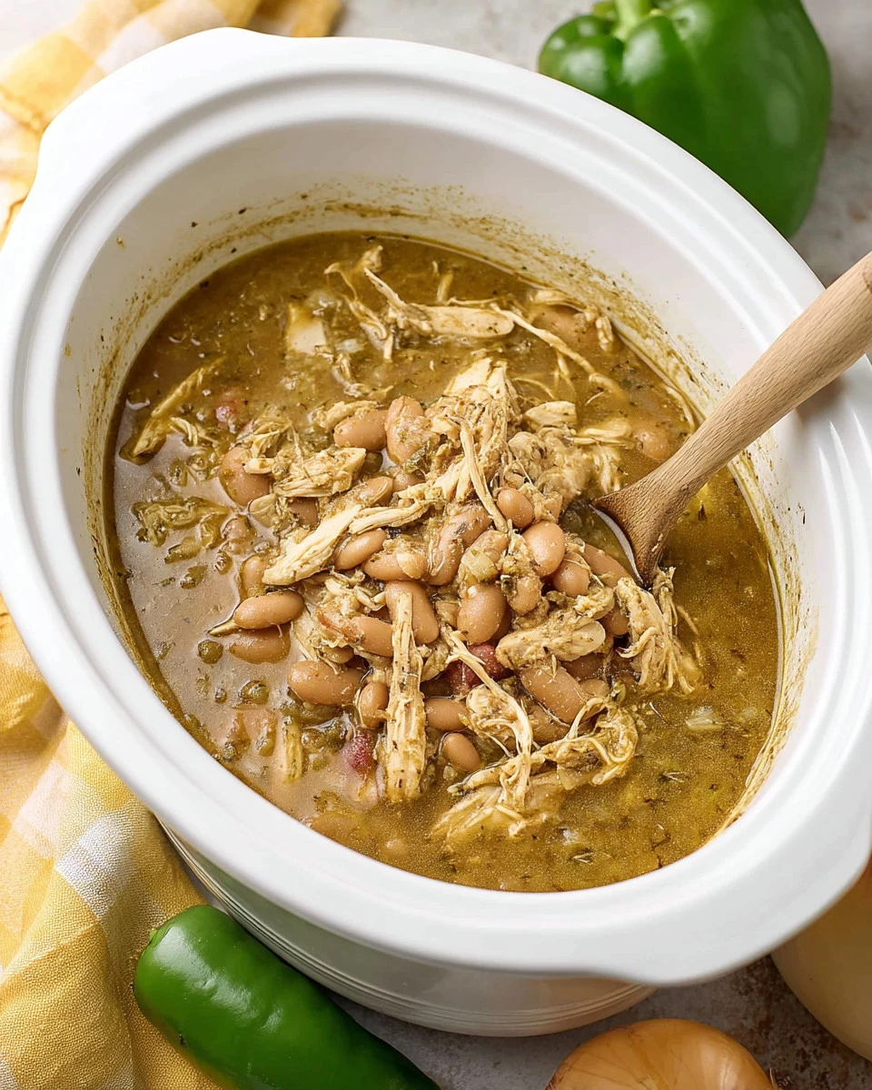 Bowl of easy slow cooker white chicken chili topped with cilantro and lime.