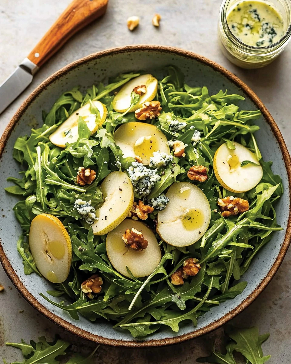 Delicious pear salad topped with blue cheese and fresh rocket leaves