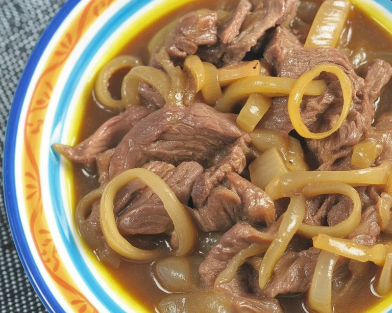 Delicious Bistek Tagalog beef steak served with soy sauce and garlic marinade.