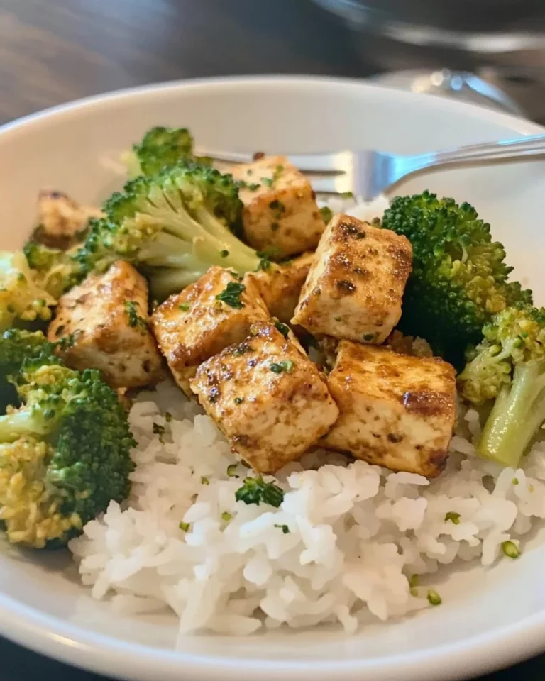 Sheet Pan Black Pepper Tofu with Broccoli ready to serve on a wooden board.