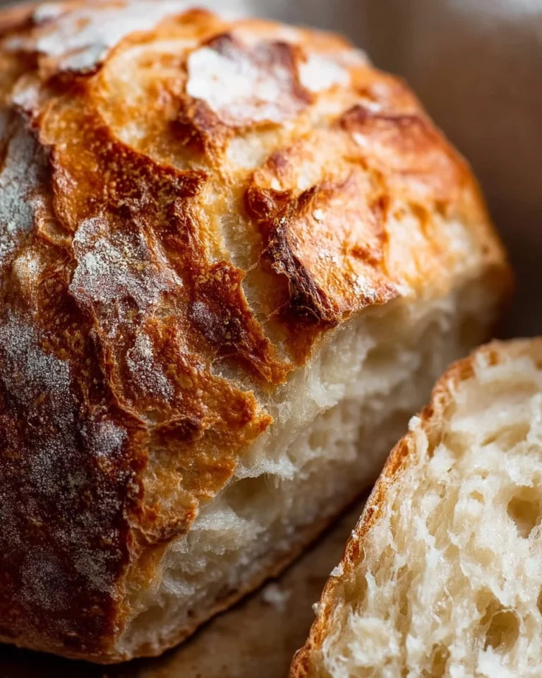 Freshly baked yeast bread on a wooden table, perfect for beginners.