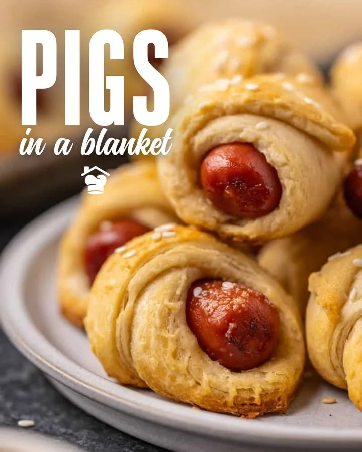 Homemade pigs in a blanket served on a plate, ideal for parties and snacks.