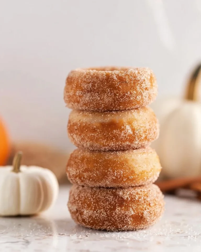 Delicious homemade pumpkin spice donuts on a plate with autumn decorations